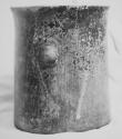 Black-brown cylinder with shallow pre-slip or polish grooved decoration