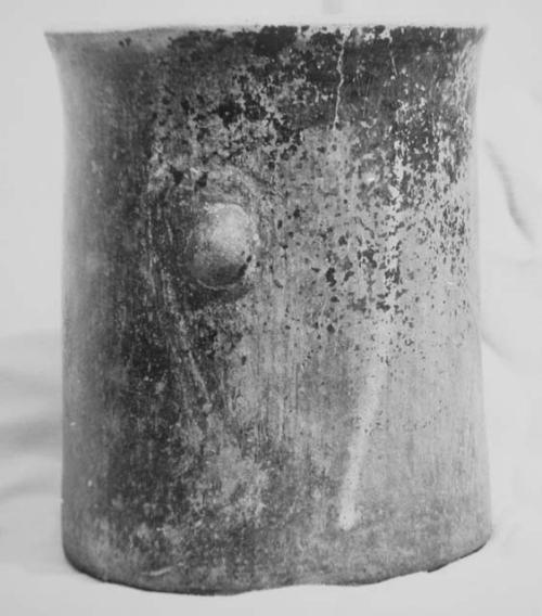 Black-brown cylinder with shallow pre-slip or polish grooved decoration