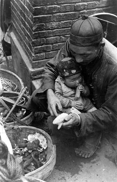 Man crouching with child