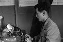 Man typing on manual typewriter.