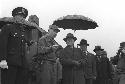 General Richard Seabury Whitcomb (center left) with President Syngman Rhee (under umbrella)