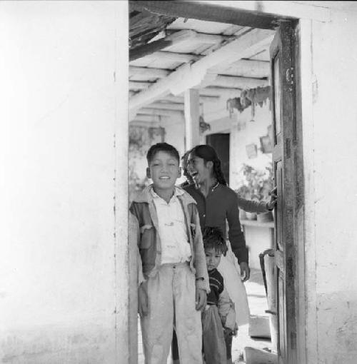 Woman with children in doorway