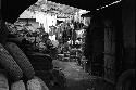 Looking into courtyard with clotheslines; piles of tires lying around.