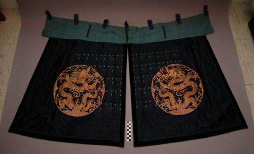 Thigh guards, indigo cloth, embroidered gold dragons, riveted metal plates