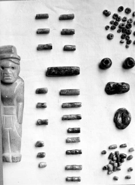 Jade beads, pendants, and human figure from Cache in Md. C-III-6