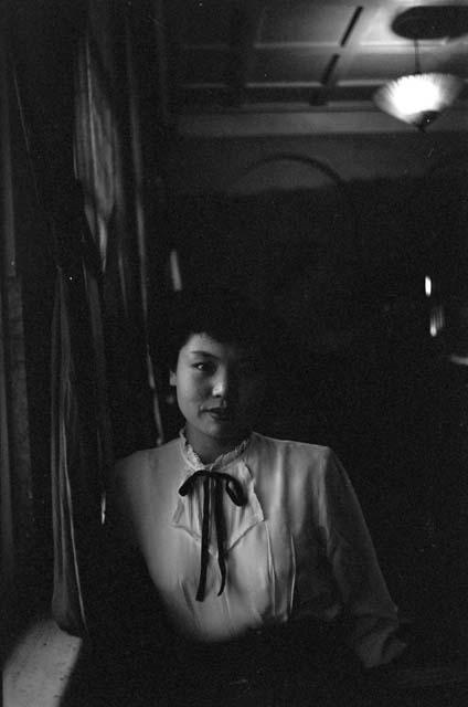 Woman with ribbon tie blouse.