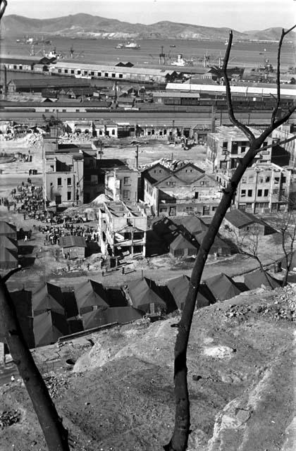 View of buildings of city from above, port in background