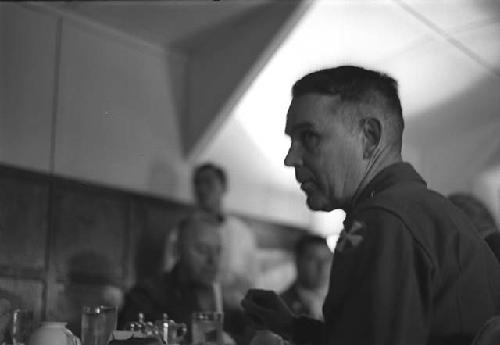 Military man sitting in Dining Hall.