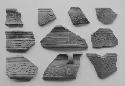 Coarse incised brown-black potsherds (10)