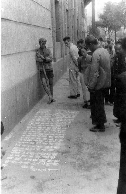 Group of people staring down at street