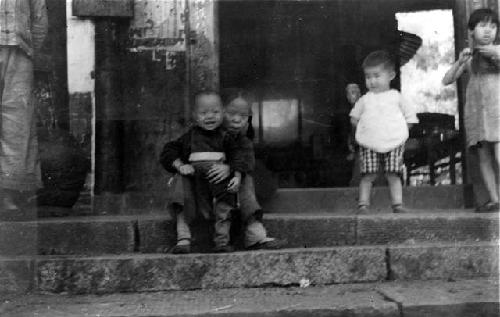 Children playing on sidewalk