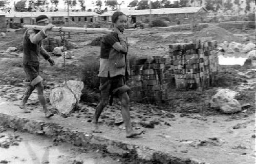 Men carrying rock