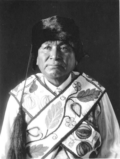 Native American wearing fur hat