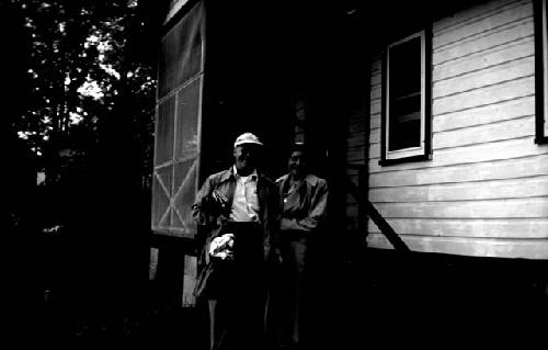 Man and woman standing outside house