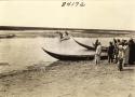 Life scene river with small boats and men Marsh Arab Iraq