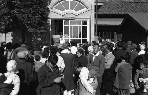 Crowd; Building with Fan Window