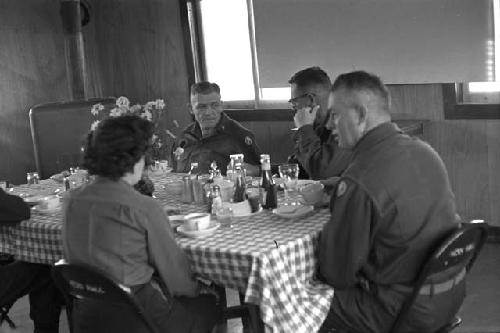 Three Military Men; One Military Woman; Table; Food