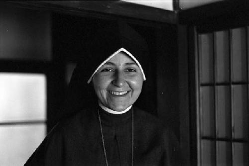 Nun in black habit smiling.