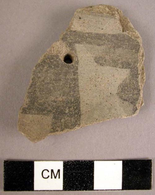 Black-on-grey potsherds, one perforated