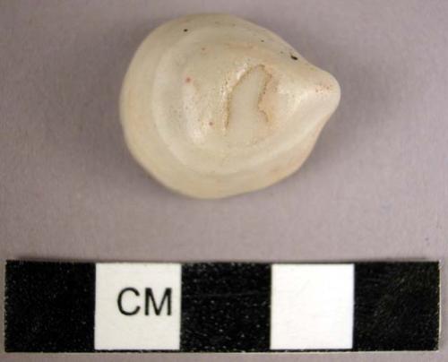 Stone, ground stone pebble, white, ovate, striated, abraded flat 1 side