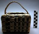 Basket, square, woven fiber, brown and buff strips, bale handle, broken areas