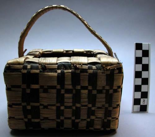 Basket, square, woven fiber, brown and buff strips, bale handle, broken areas