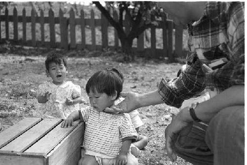 Man touching a baby under the chin