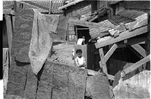 View of a man in a courtyard between houses