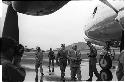 Man in a suit walking towards an airplane