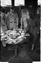 Three men and a woman looking over some photographs