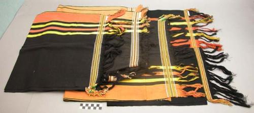 Cloths woven and worn by men (black with orange & yellow borders)
