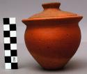 Small model of conical pottery vessel and lid, with pierced bottom for +