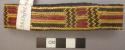 Plaited fern bracelet ("adiadi") - yellow, black, and red, worn as decorations b