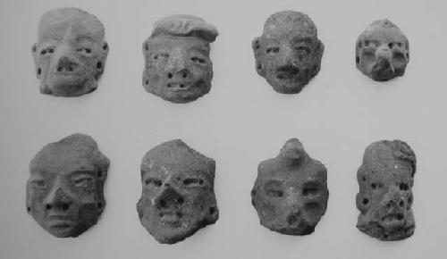 Figurine heads (8), all read slipped save perhaps #8, weathered.