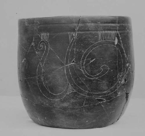 Blade-brown "goblet" with face on wall, fine incised