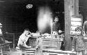 Children in front of man with bowls and food