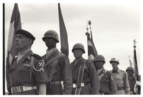 Soldiers holding flags of their respective nations at U.N. cemetery Memorial Day ceremony