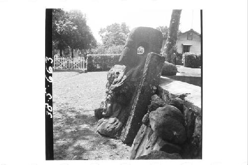 Huge stone head with headdress in the round (left profile)