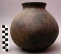 Globular unglazed, brown-ware ceramic vessel with flattened base