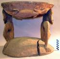Large wooden stool with two carved heads