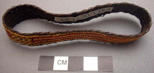 Basketry arm band - dark brown with red & yellow design