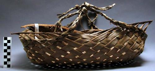 Woven market basket. 17.5 in. long. made of coconut palm.