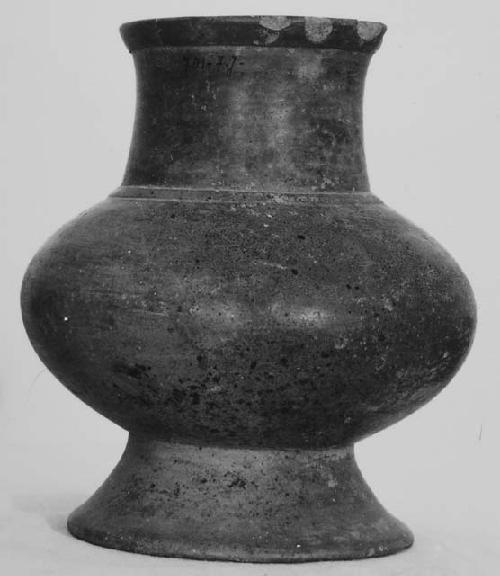 Tripod white on red bowl (A); Orange pedestal vase (B).