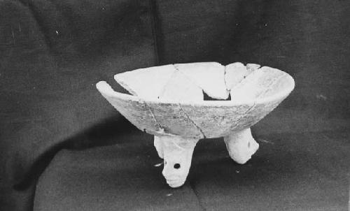 Tripod dish of Mayapan red ware.  Mended.  With human heads as feet.