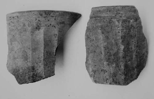 Sherds of vertically facetted brown-black and red undecorated cylinders (2)