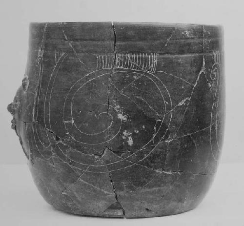 Blade-brown "goblet" with face on wall, fine incised