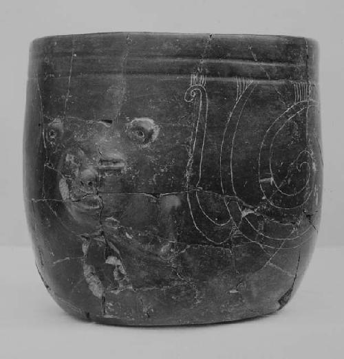 Blade-brown "goblet" with face on wall, fine incised