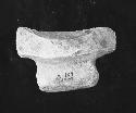 Fragment of grooved three legged metate, Lot A-104