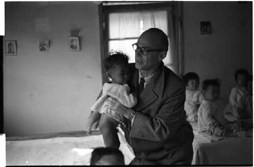 Man lifting a baby