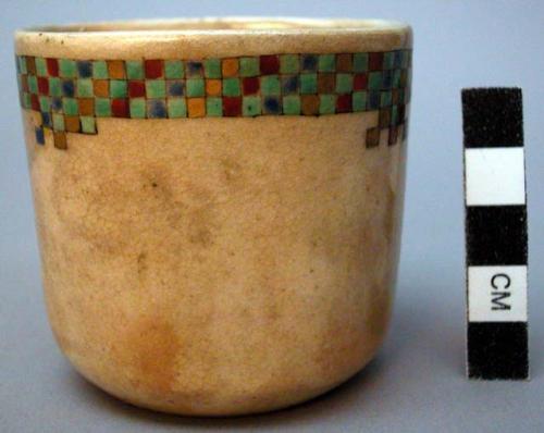 Ceramic cup with checked border design